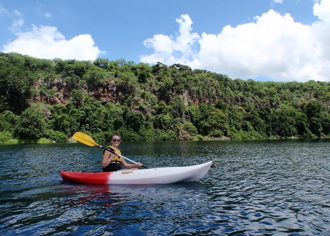Client swimming in Lake Chala crater lake during Tanzania nature tour and Mount Kilimanjaro day trip adventure