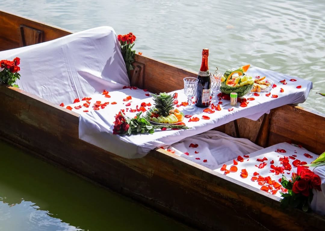 Boat at Lake Duluti with flowers and picnic food during Arusha nature tour and canoeing safari experience in Tanzania