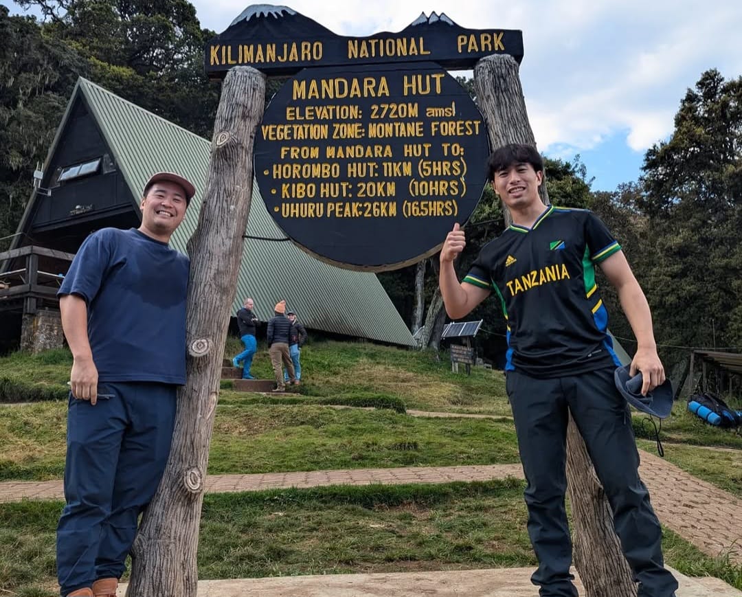Friends hiking on Mount Kilimanjaro during a day trek, enjoying scenic trails and mountain views in Tanzania