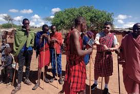 Maasai warriors wearing traditional red shuka and beadwork in Tanzania