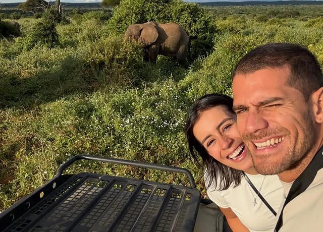 Couple taking selfie in safari jeep with elephant beside vehicle during Tanzania Wildlife Safari and Big Five game drive in Tarangire National Park