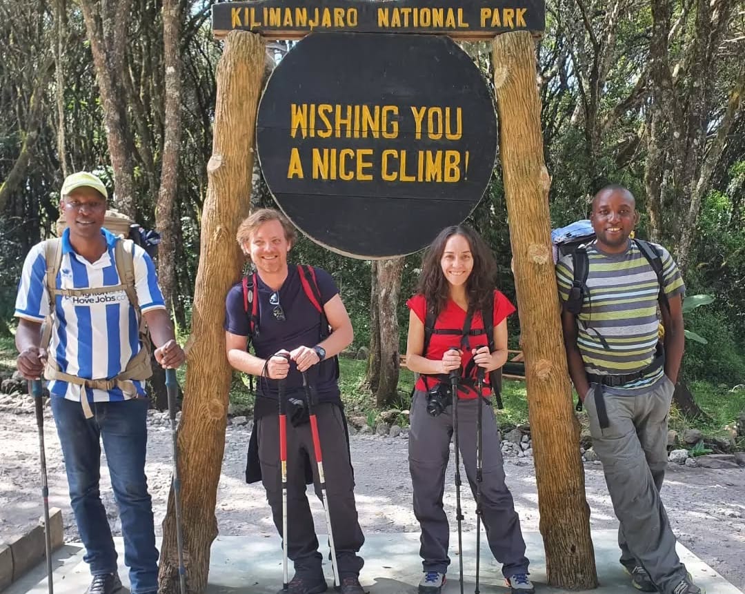 Climbers at the starting point of the Rongai Route on Mount Kilimanjaro, preparing for trekking through the northern trail in Tanzania.