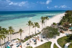 Scenic view of Kendwa Beach, Zanzibar, featuring golden sands, clear turquoise waters, and a serene tropical setting