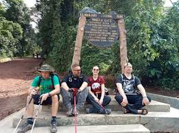 Hikers pausing to enjoy breathtaking sunrise views from the Rongai Route trail on Mount Kilimanjaro.