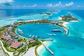 Aerial view of Zanzibar’s tropical beach with turquoise waters and tourists relaxing