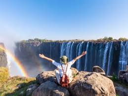 Panoramic view of Victoria Falls with mist and rainbow