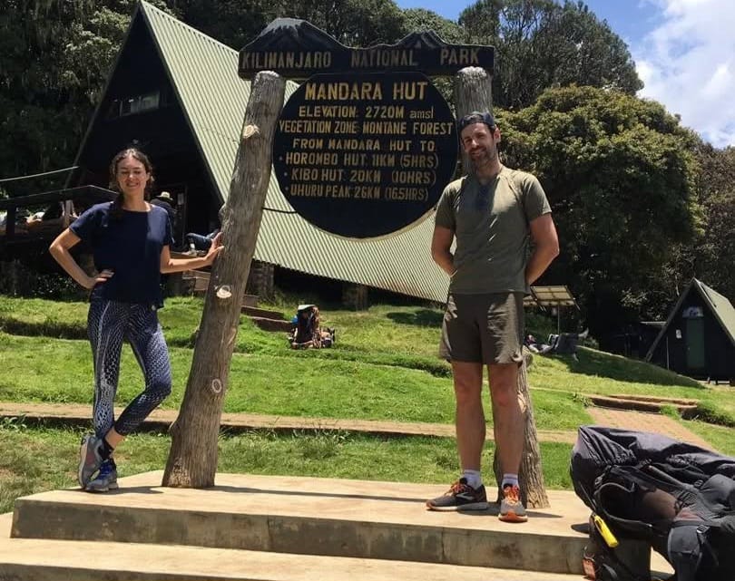 Climbers on a day hike to Mandara Hut on Mount Kilimanjaro, trekking through lush rainforest along the Marangu Route in Tanzania