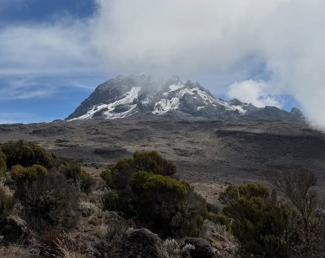 Scenic view of Mount Kilimanjaro from the Machame Route, showcasing lush rainforest slopes and dramatic mountain landscapes in Tanzania