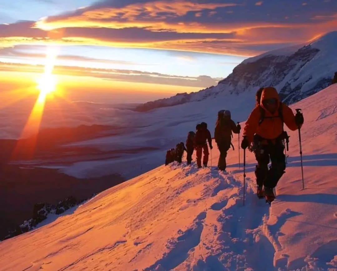 Climber at Barafu Camp on Mount Kilimanjaro standing on rocky alpine terrain before the summit ascent in Tanzania