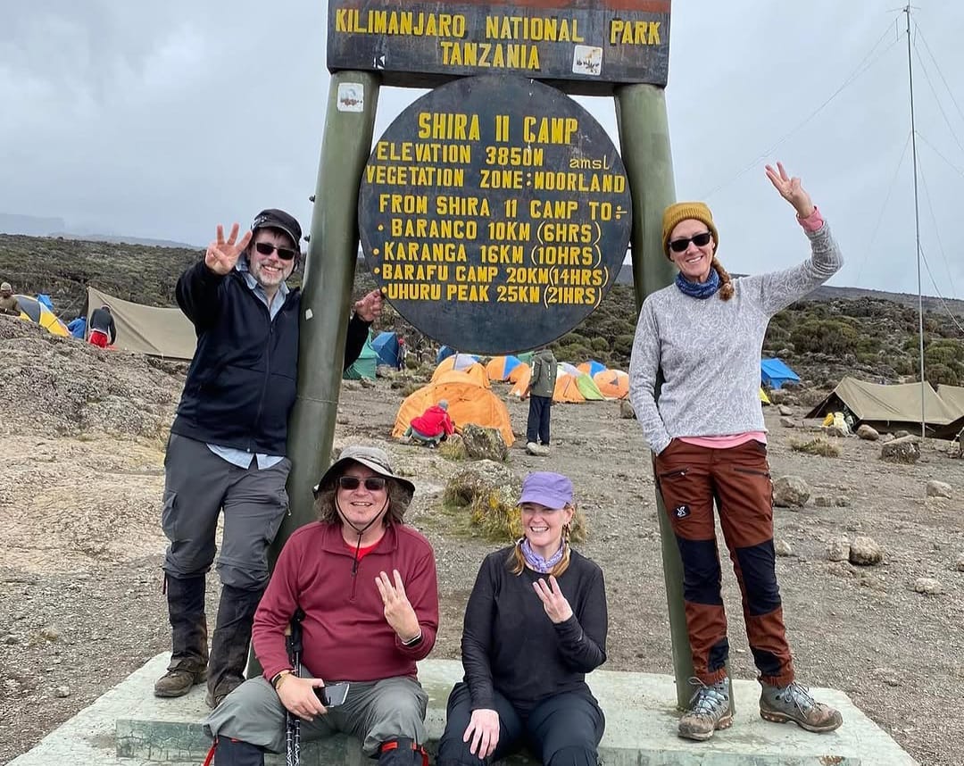 Climbers reaching Shira II Point on Mount Kilimanjaro via the Rongai Route, enjoying high altitude views and alpine landscape in Tanzania.