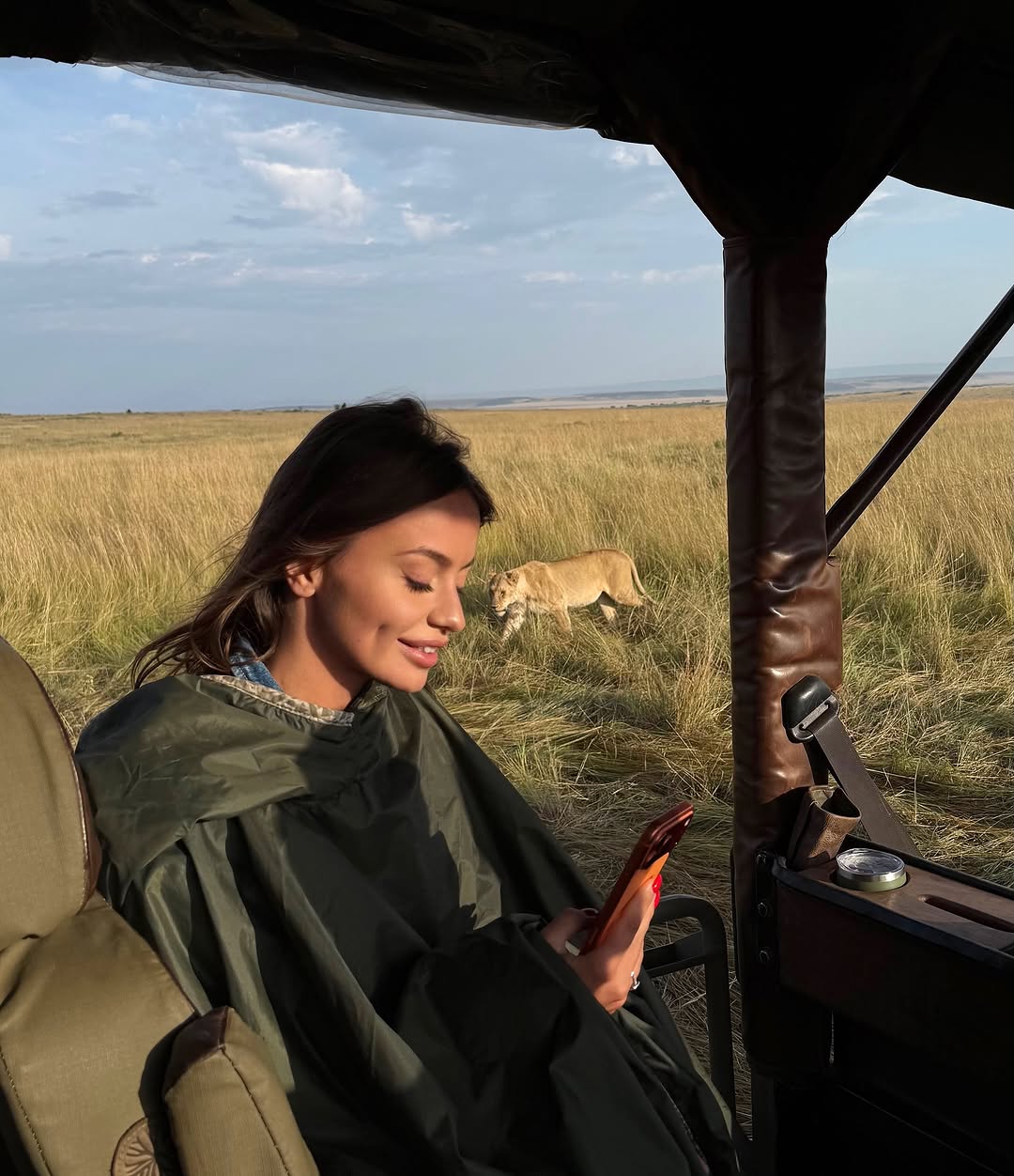 Tourist on Tanzania safari watching a resting lion in Serengeti National Park with Nelwen Tours & Safaris